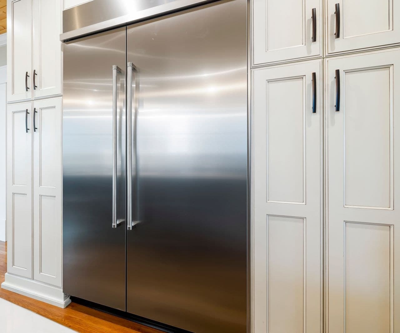 High-end built-in stainless side-by-side refrigerator flush with kitchen cabinets